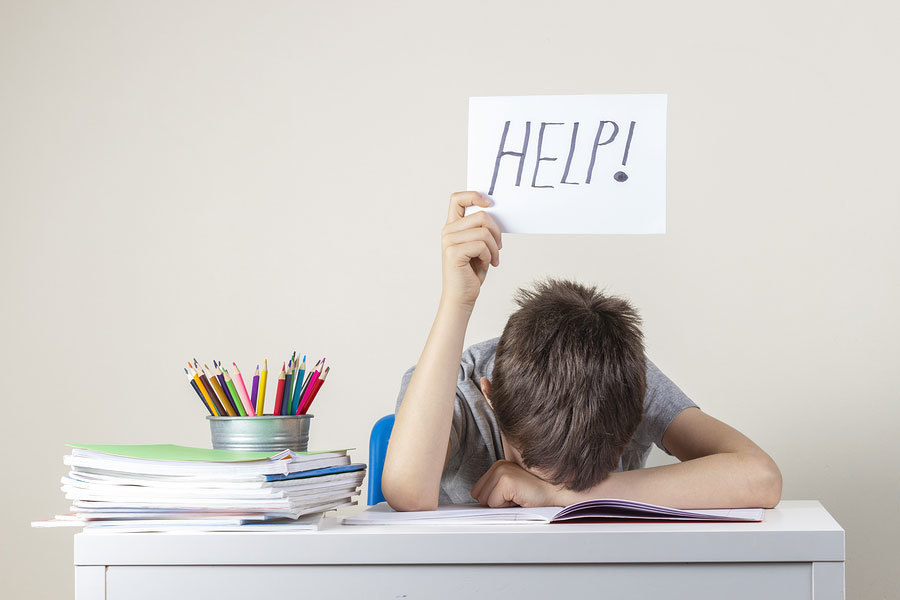 student holding a help sign