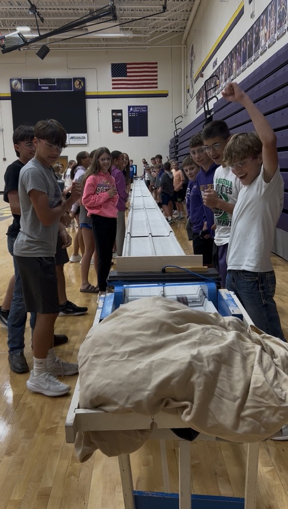 Students cheer for their car to win the race.