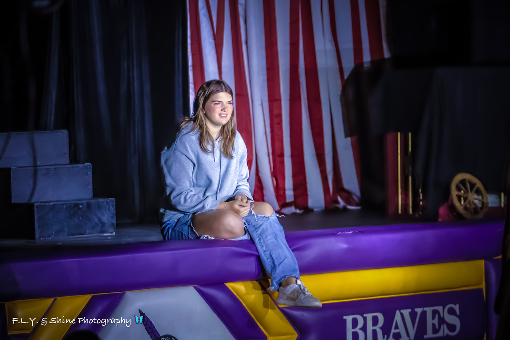 Actress sitting at the edge of stage