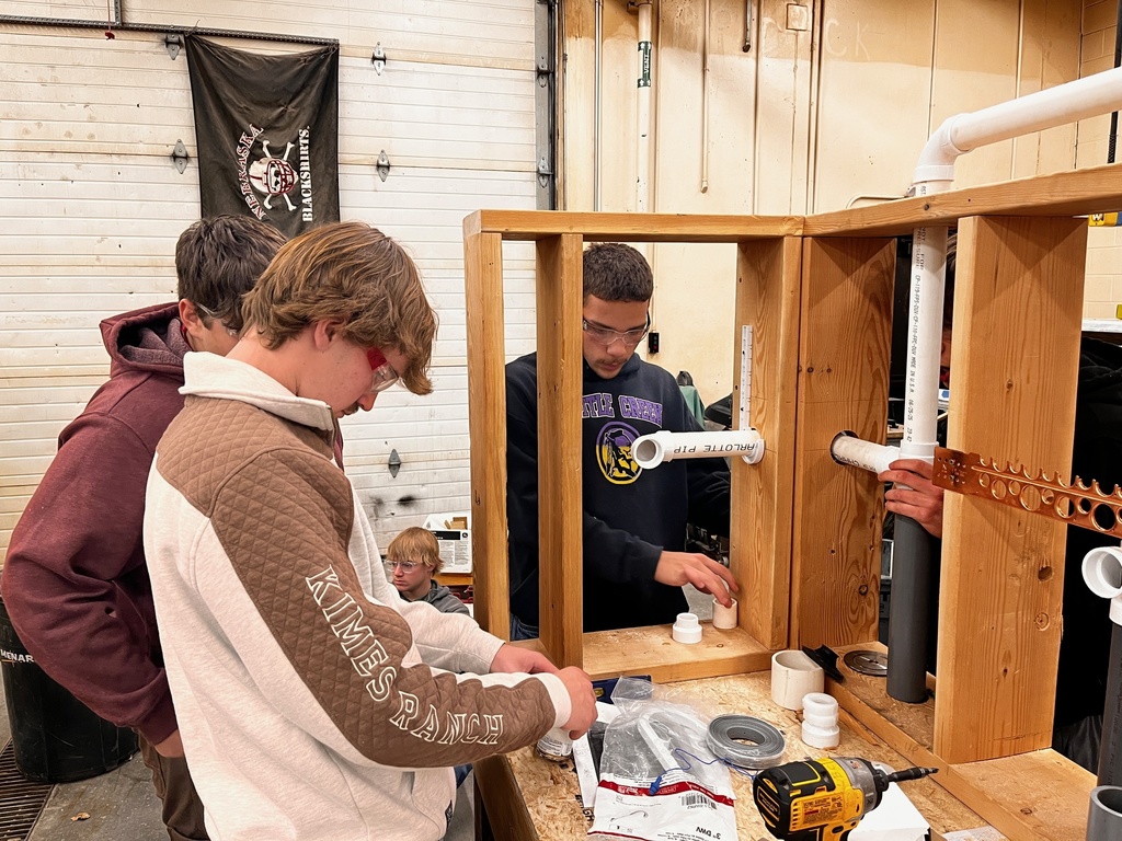 Students prime and glue PVC fittings and pipe together.