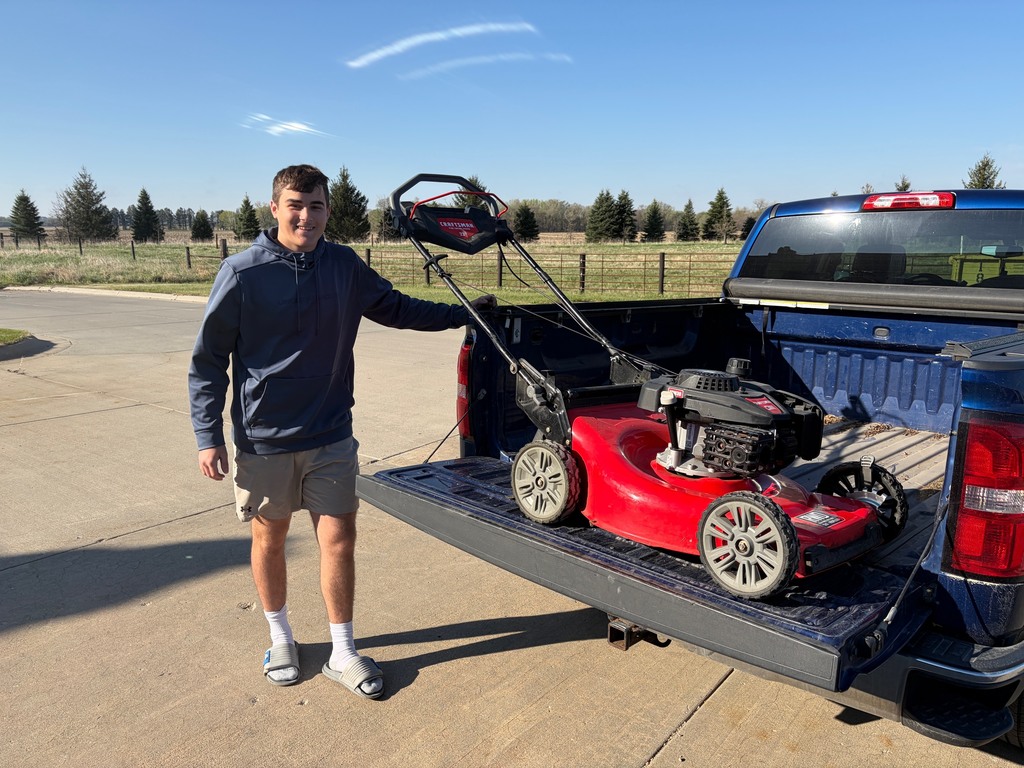 A student takes his mower home after fixing an oil leak and sharpening the blade.