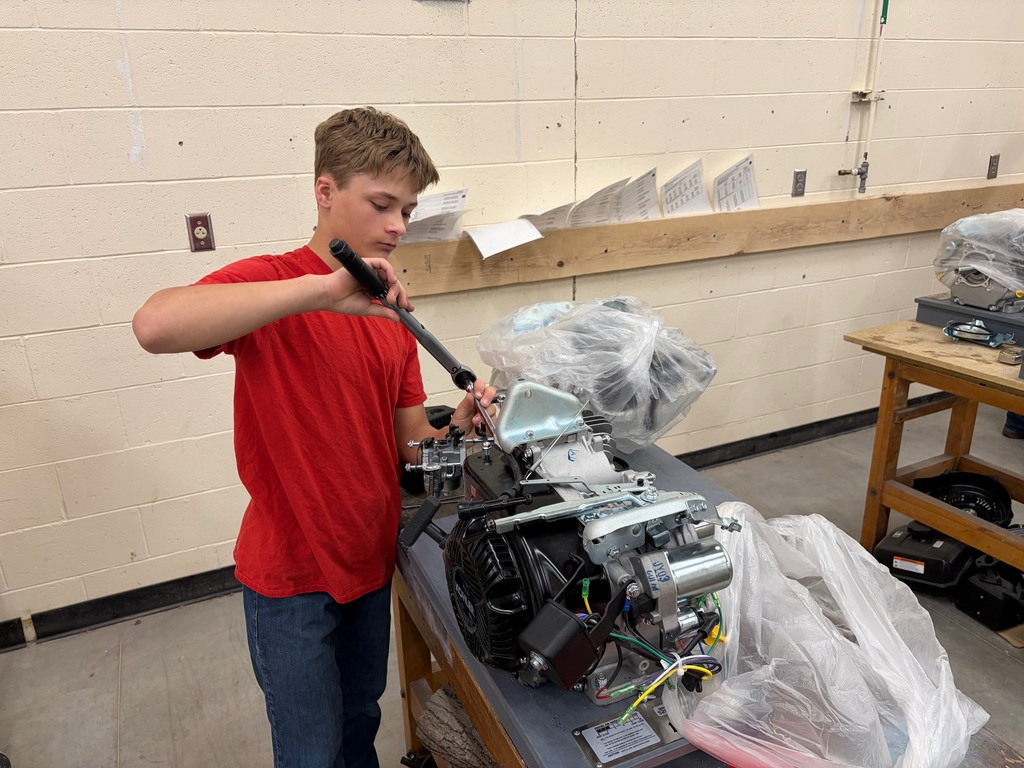 A student torques the cylinder head down.