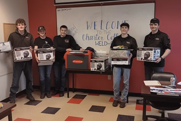 Students display the prizes they earned for top marks in the Charter College welding competition