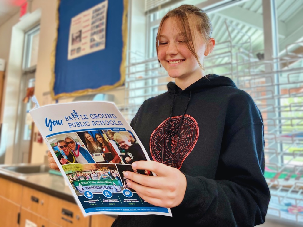 A student reads the third publication of Your Battle Ground Public Schools