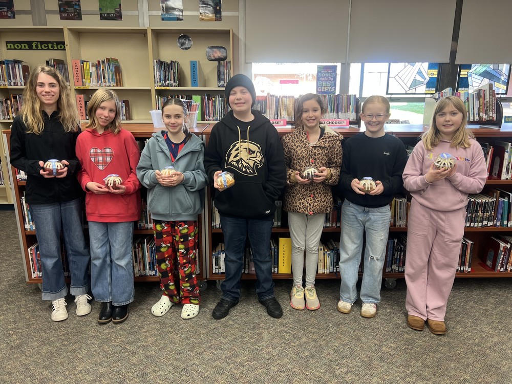 kids showing their reward the bundt cake