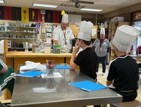 Students watch a cooking demonstration