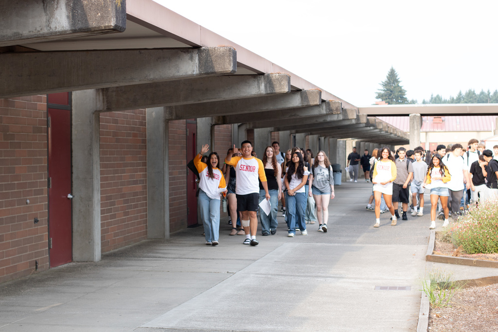 Student wave as they take a tour of Prairie High School on the first day of the 2025-26 school year.