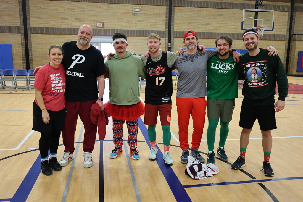 Staff members who won the school's red and green games pose for a photo.
