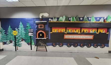 Classroom door decorated with a winter scene and a train called the Tiger Express.