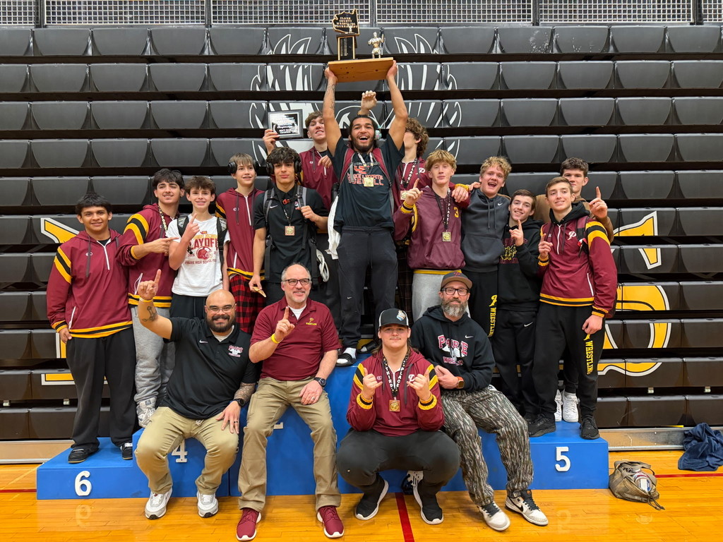 Wrestlers display their trophy