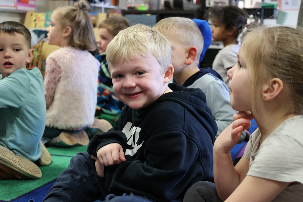 A Transitional Kindergarten student smiles at the camera