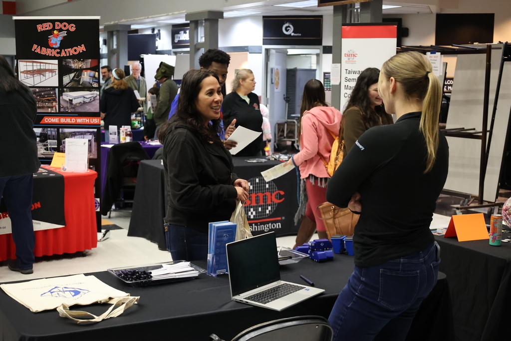 A vendor speaks with an attendee at the 2026 Industry Fair