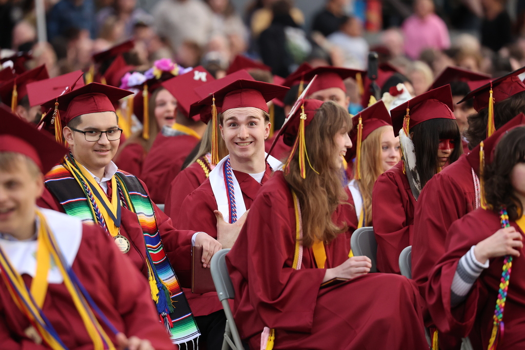 A grad grins at the camera during the ceremony.