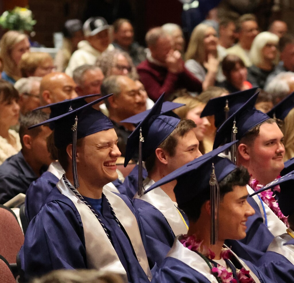 Laughing student in cap and gown
