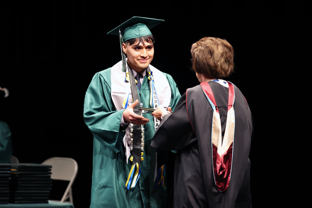 Graduate accepts a diploma.