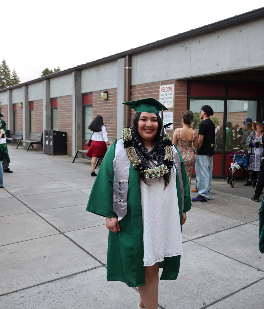 A graduate smiles for the camera.