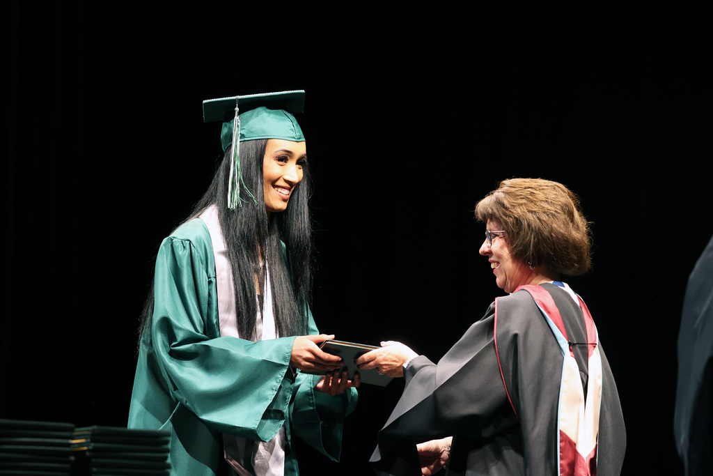 A Summit View High School grad accepts a diploma.