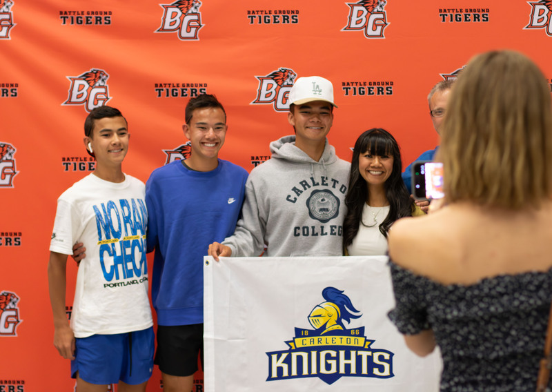 a group of boys hold a sign that says "knights"