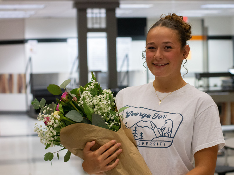 Camille Cresap holds flowers and smiles