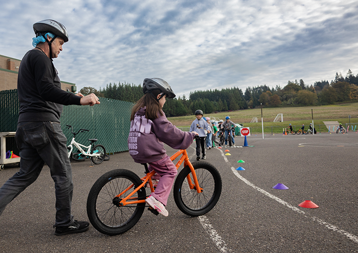 a student rides her bike for the very first time