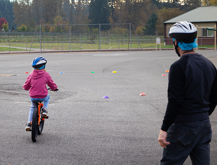a student rides her bike for the very first time
