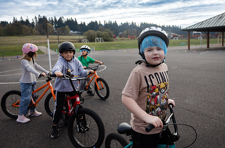 a group of students ride bikes together