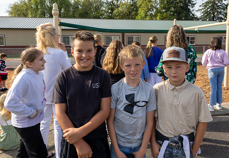 three boys smile for the camera