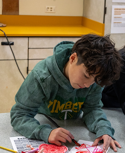 boy drawing with red marker