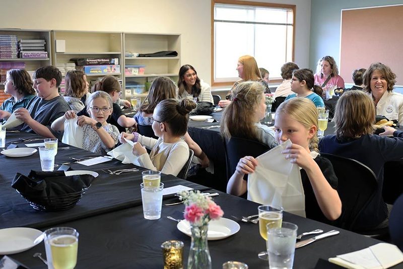 kids sit together with adults