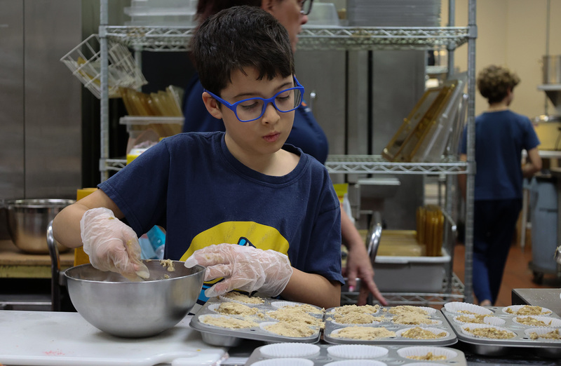 A student preps gluten-free muffins