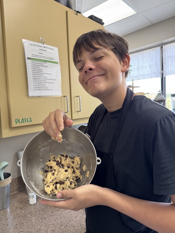 Student holding cookie dough