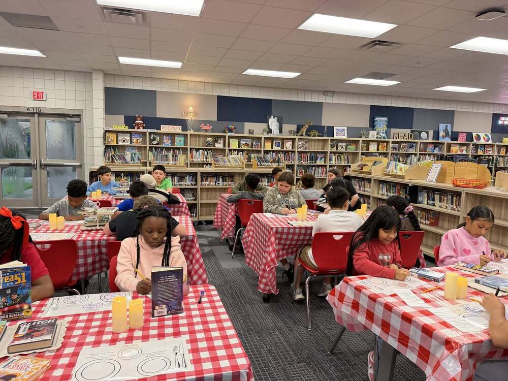 students looking at books