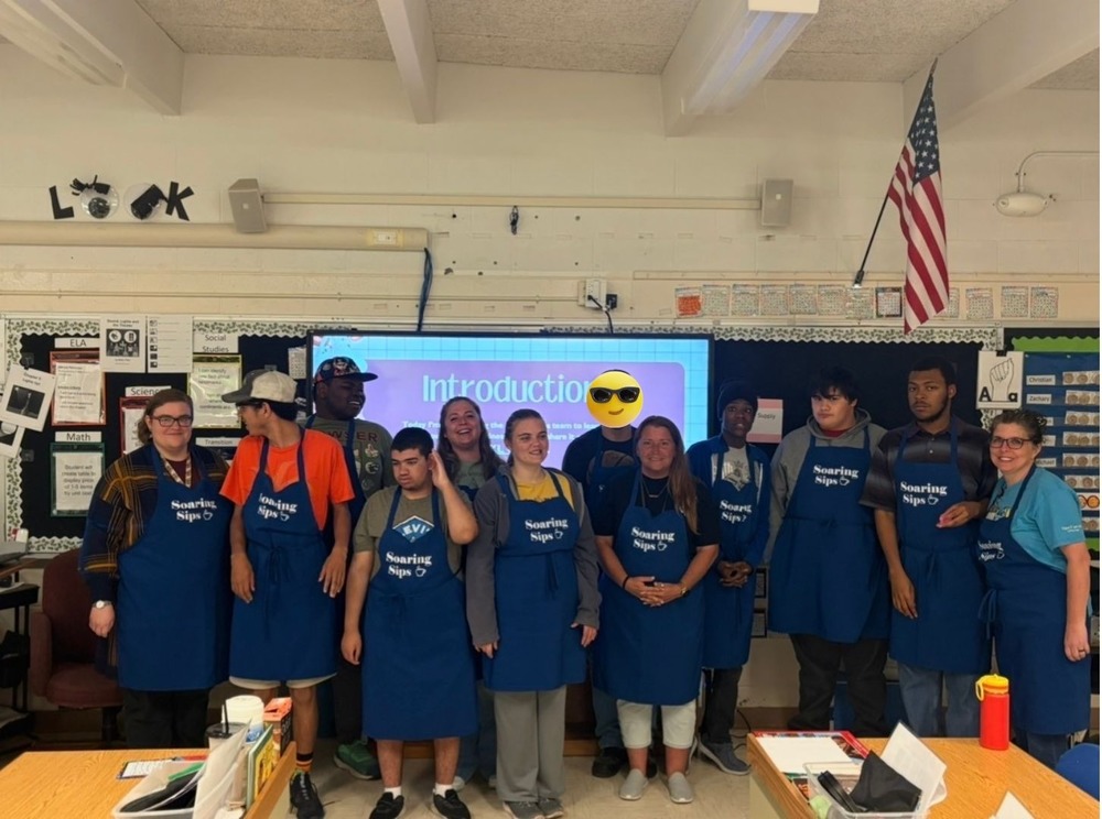 Students in Palmer’s Pac pose together during their Soaring Sips interview, smiling and celebrating their student-run coffee shop at Margaret K. Lewis School.