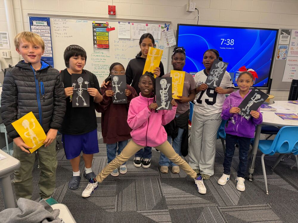 Students holding this bone paintings