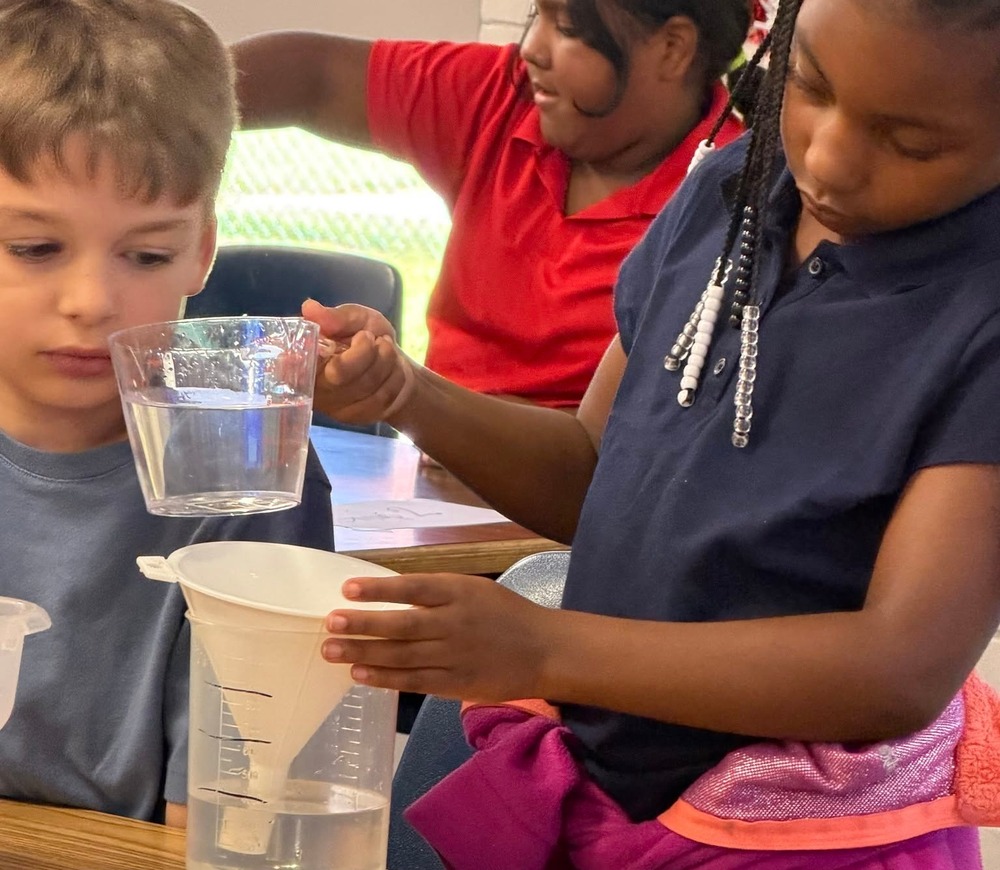 Students using funnel and measuring cups