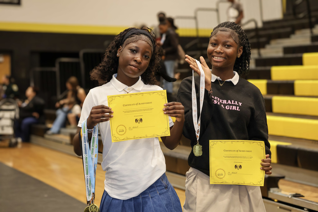 Two students show off their awards