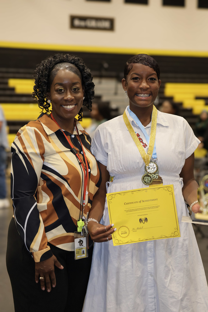 A Proud parent smiles with her daughter after the awards ceremony