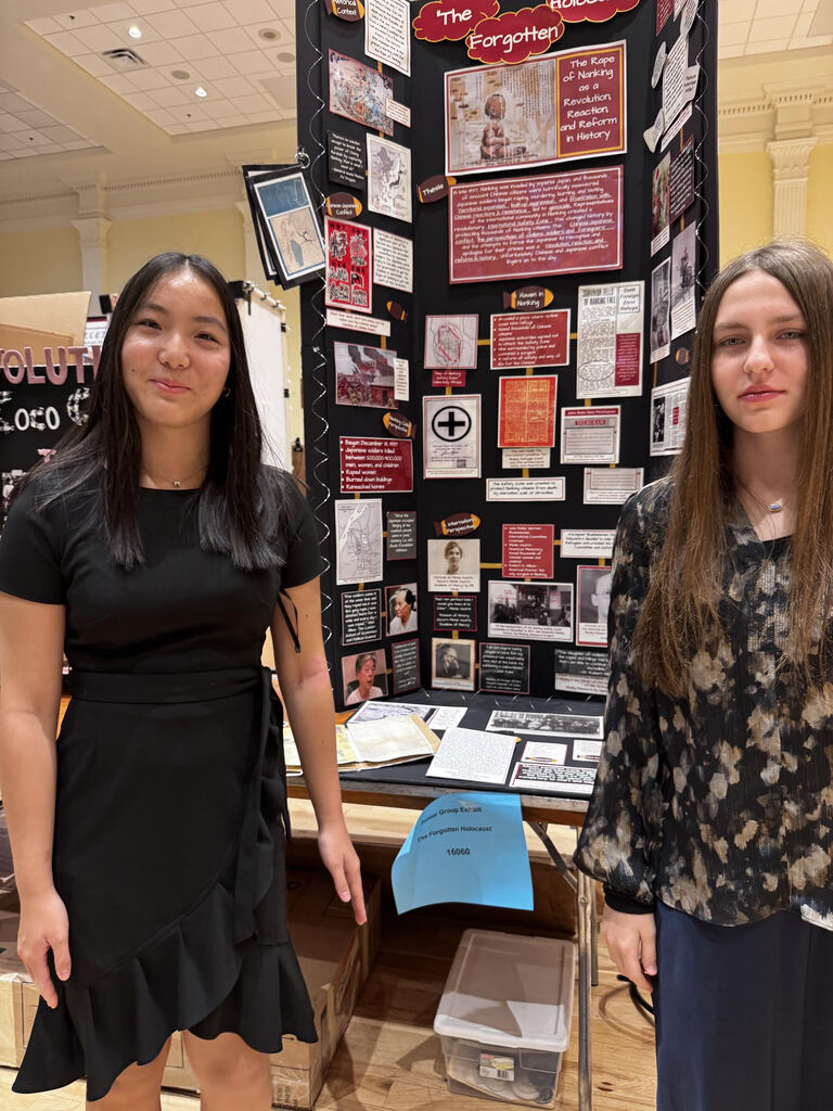 Natalie Xiao and Violet West with their group exhibit at the National History Fair