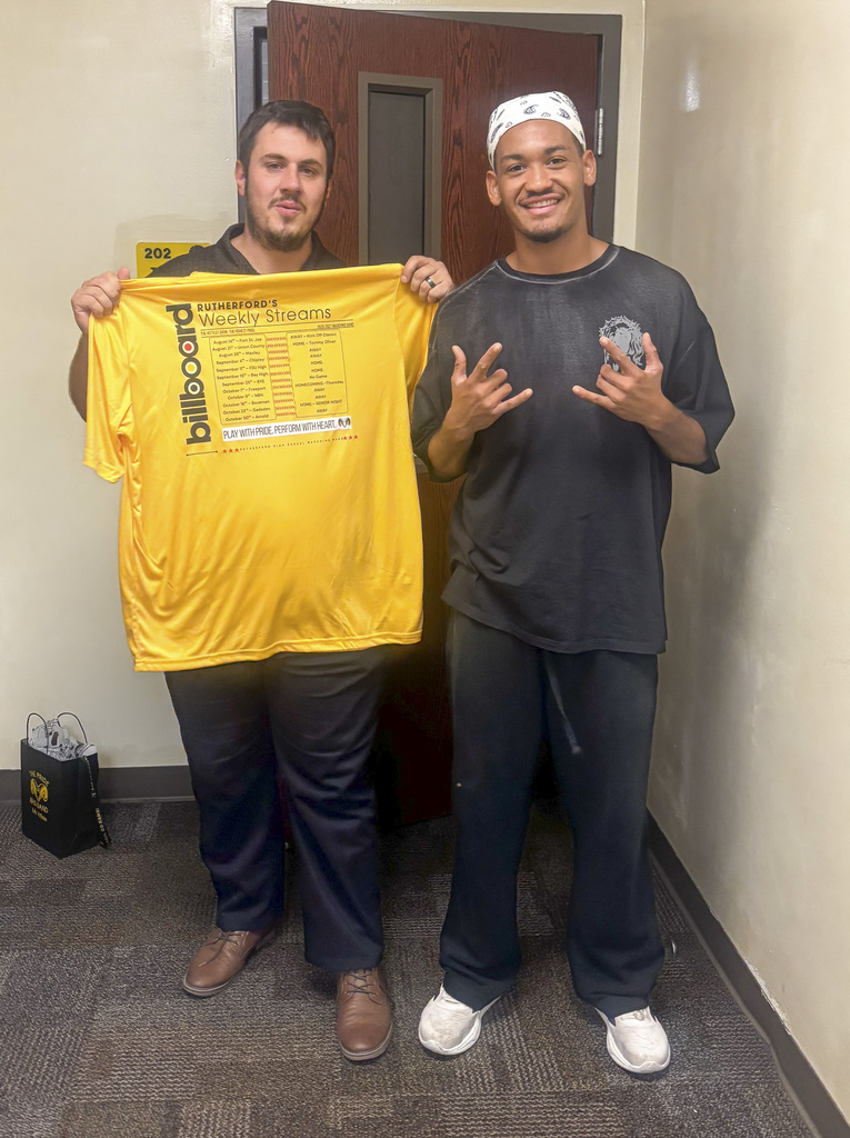 Mr. White receives a show shirt from a band member