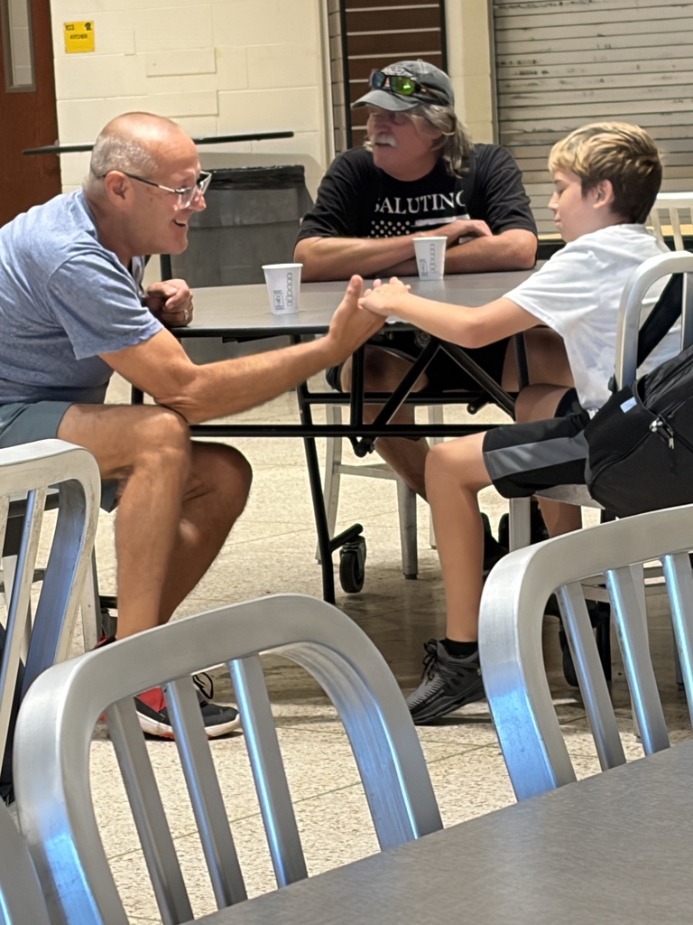 A grandfather tells his grandson why he is proud of him at an All Pro Dad meeting.