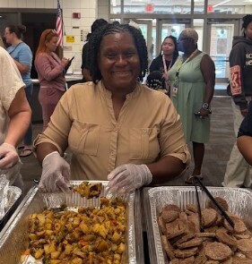 Katina Williams, our Family & Community Engagement Coordinator, serves breakfast