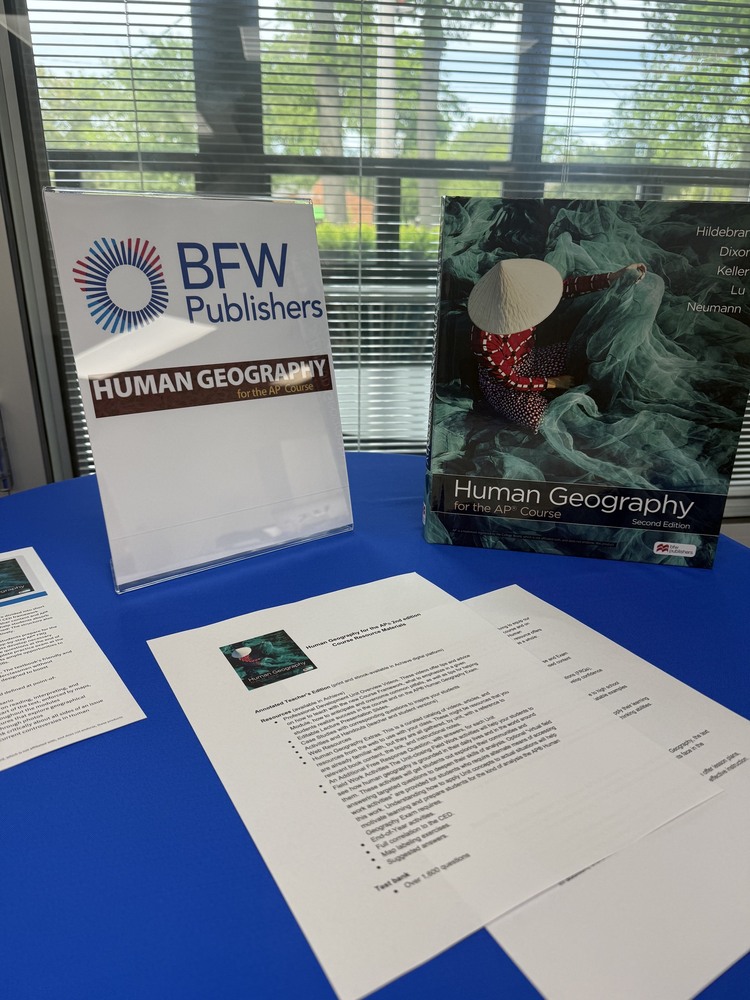 AP Human Geography Curriculum materials being considered for adoption sitting on a table.