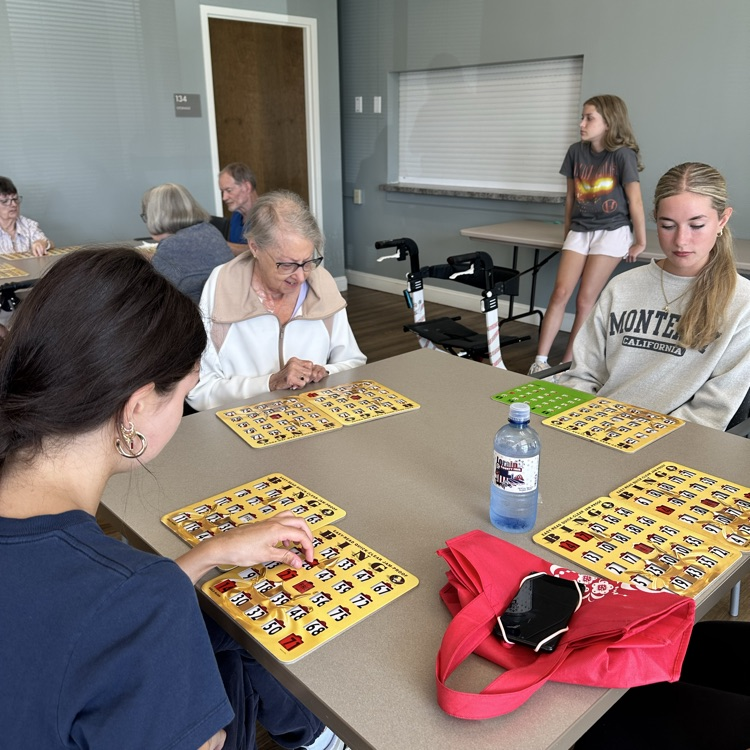 Bay High school key club volunteers assist with bingo at the Knickerbocker apartments photo