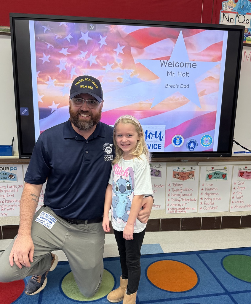 Mr. Nathan Hold, Coastguard Veteran, reads to first-graders in Mrs. Poretsky's class in celebration of Veterans Day