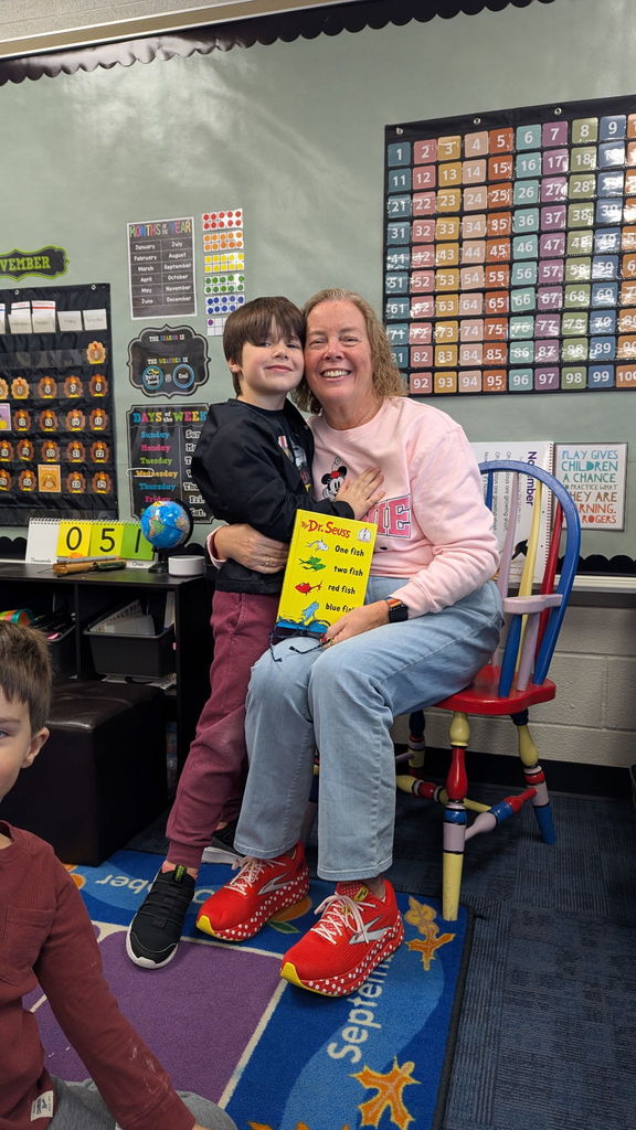 mystery reader board president amy huntley with her grandson
