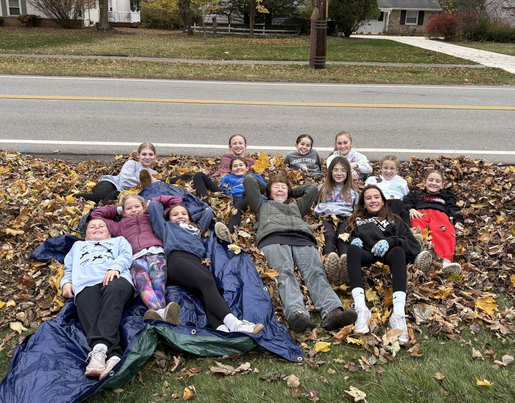 happy homeowner with bay middle school girls at the rake out event 2025