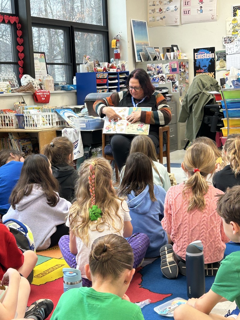 mrs. debbie callihan, board president, reads with mrs. hart's second-grade class photo