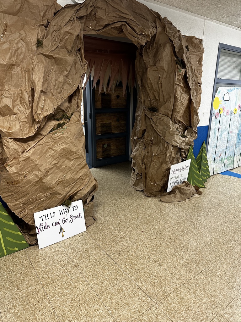 a handmade cave entrance leads to the library for the book big foot little foot by ellen potter
