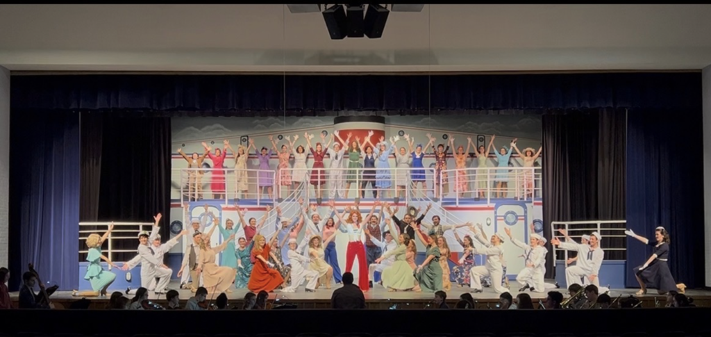 a photo from bay high school's spring musical anything goes showing students in a dance number on a ship set