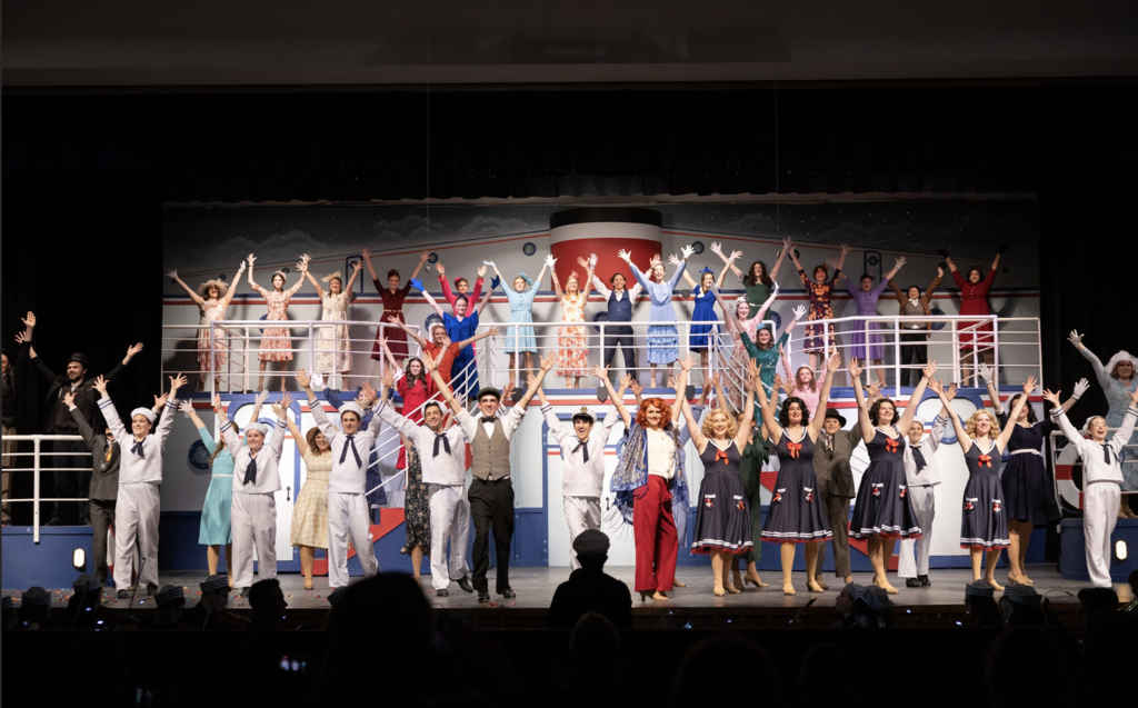 a photo from bay high school's spring musical anything goes showing students in a dance number on a ship set